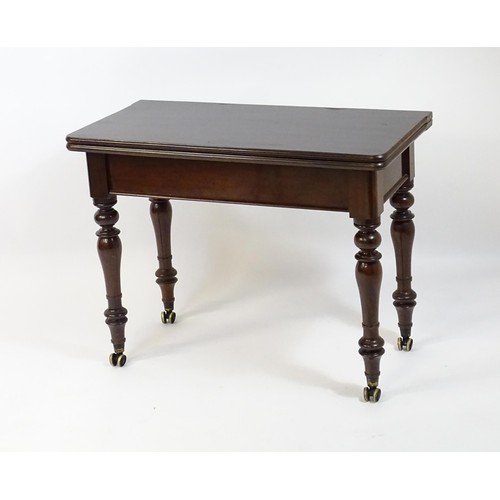 1623 - A 19thC mahogany tea table, with a hinged top above four turned tapering legs terminating in unusual... 