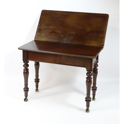 1623 - A 19thC mahogany tea table, with a hinged top above four turned tapering legs terminating in unusual... 