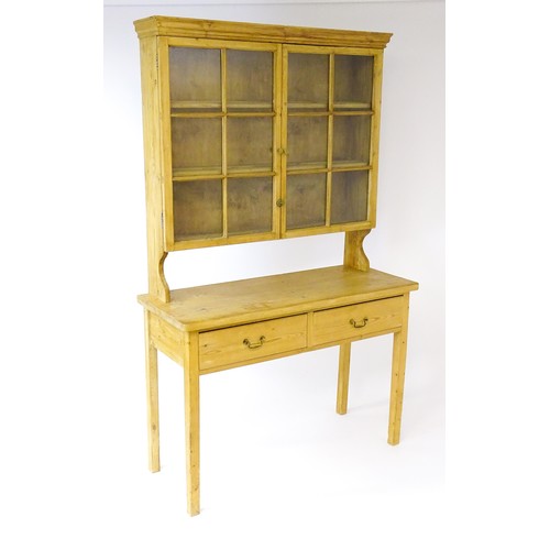 1646 - An early 20thC pine dresser with a moulded cornice above two astragal glazed doors and two short dra... 