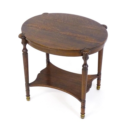 1794 - A 19thC oak occasional table with an oval top raised on four turned reeded legs with gadrooned termi... 