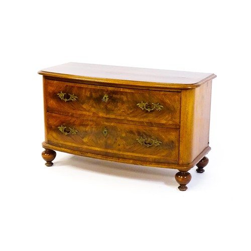 1594 - A late 19thC / early 20thC mahogany chest of drawers, with a bowed front and burr veneered inlaid de... 