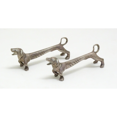 1192 - A pair of 20thC novelty knife rests modelled as dachshund dogs. Approx. 3