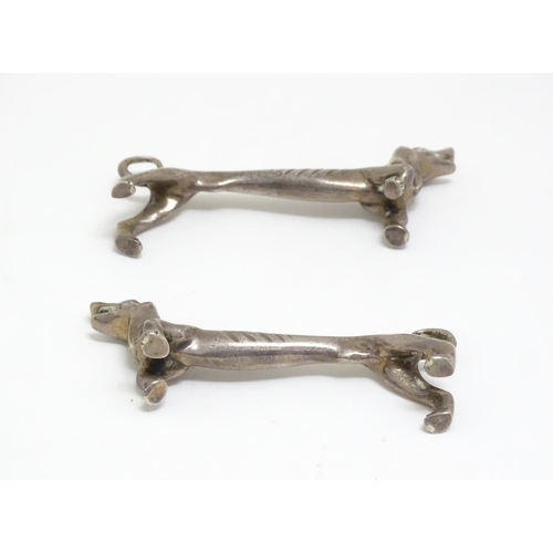 1192 - A pair of 20thC novelty knife rests modelled as dachshund dogs. Approx. 3