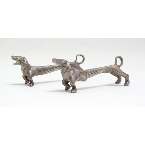 1192 - A pair of 20thC novelty knife rests modelled as dachshund dogs. Approx. 3