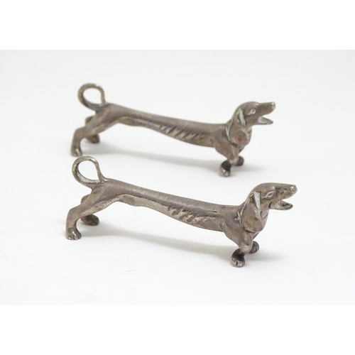 1192 - A pair of 20thC novelty knife rests modelled as dachshund dogs. Approx. 3