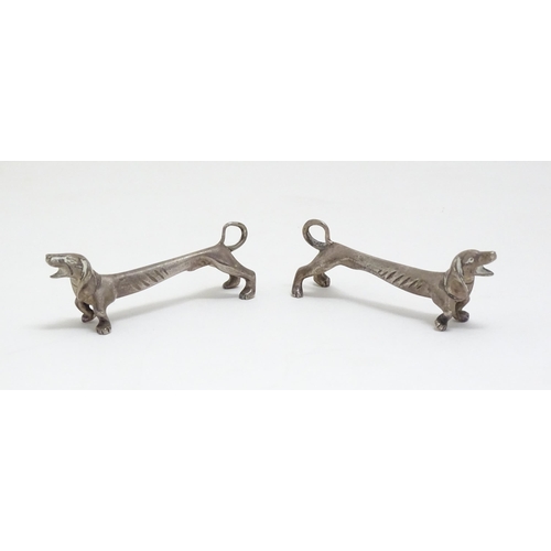 1192 - A pair of 20thC novelty knife rests modelled as dachshund dogs. Approx. 3