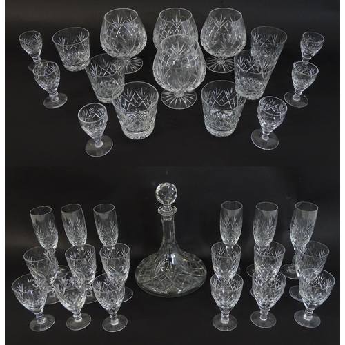 303 - A large quantity of cut glass / crystal glassware to include champagne flutes,  assorted drinking gl... 