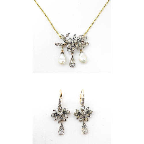 707 - A Continental 14ct gold necklace having a floral and foliate formed pedant set with a profusion of d... 