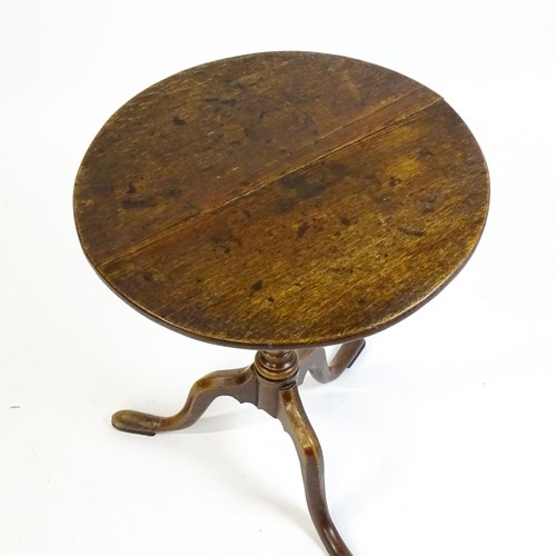 1596 - A late 18thC oak tripod table with a circular top above a tapering turned pedestal and three cabriol... 