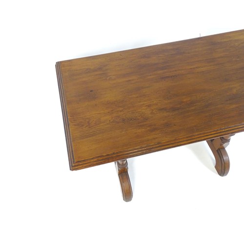 1602 - A late 19thC pine Gothic centre table, with a rectangular moulded top above four column formed taper... 