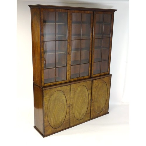 1726 - A large Georgian mahogany bookcase with a moulded cornice above three astragal glazed doors and the ... 