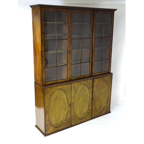 1726 - A large Georgian mahogany bookcase with a moulded cornice above three astragal glazed doors and the ... 