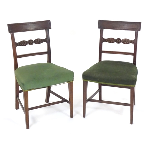 3 - A pair of Regency mahogany side chairs with a bowed top rail above a carved mid rail with draught st... 