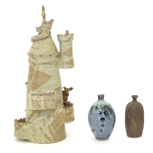 114 - Three items of studio pottery to include a model of a tower with turrets and dragon detail by a loca... 