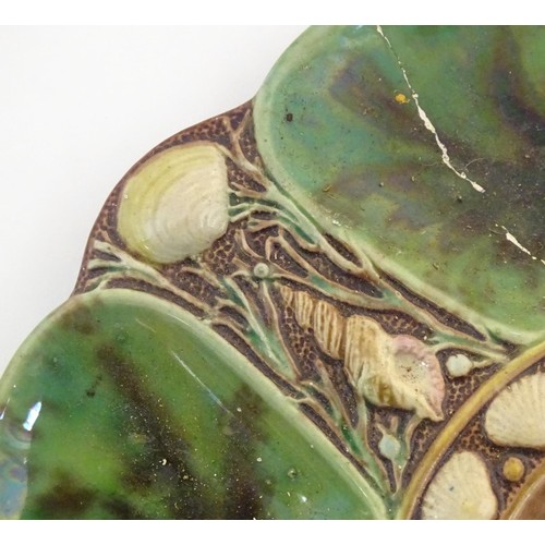 125 - A Minton majolica oyster plate with relief shell decoration. Impressed marks under. Approx. 9 1/4