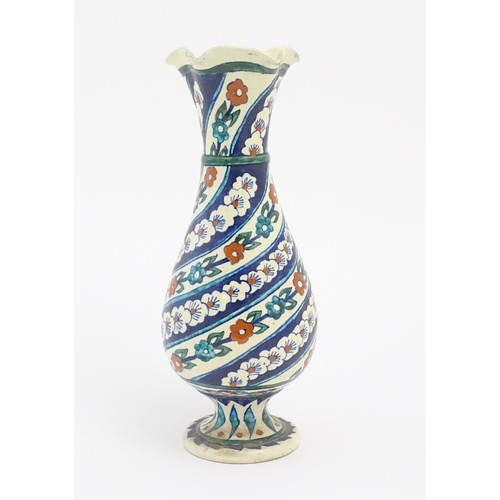 128 - An Iznik style vase with banded blue, white and red floral and foliate detail. Approx. 11 1/2