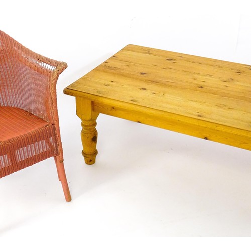 175 - A pine coffee table raised on four turned tapering legs and a Lloyd Loom style chair. The table meas... 