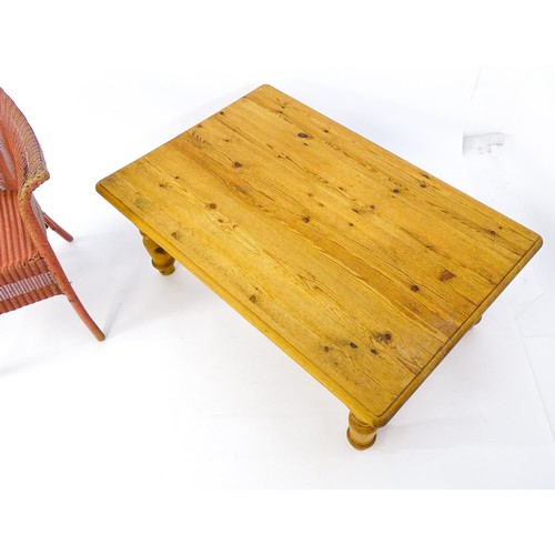 175 - A pine coffee table raised on four turned tapering legs and a Lloyd Loom style chair. The table meas... 