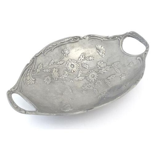 458 - A Continental Art Nouveau cast twin handled dish with relief floral, foliate and butterfly detail. A... 