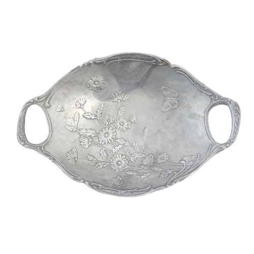 458 - A Continental Art Nouveau cast twin handled dish with relief floral, foliate and butterfly detail. A... 