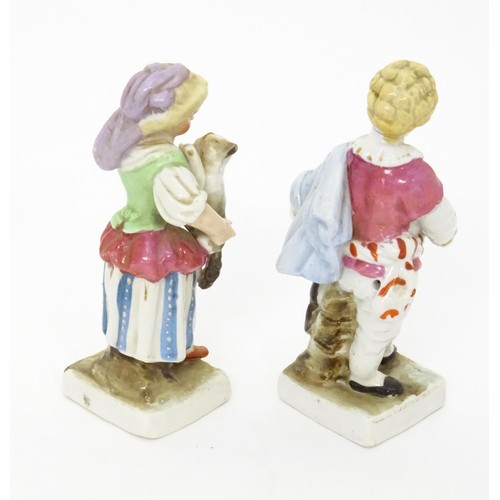 459 - A pair of Continental porcelain figurines, one modelled as a girl with a cat, the other modelled as ... 