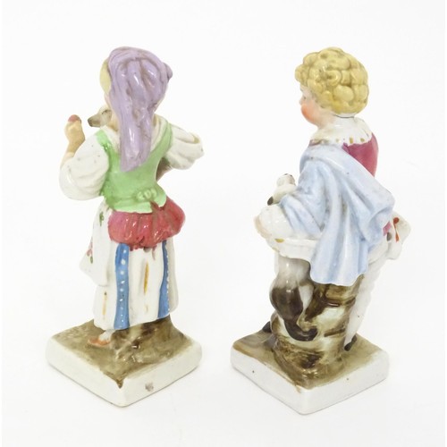 459 - A pair of Continental porcelain figurines, one modelled as a girl with a cat, the other modelled as ... 