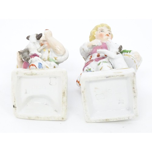 459 - A pair of Continental porcelain figurines, one modelled as a girl with a cat, the other modelled as ... 