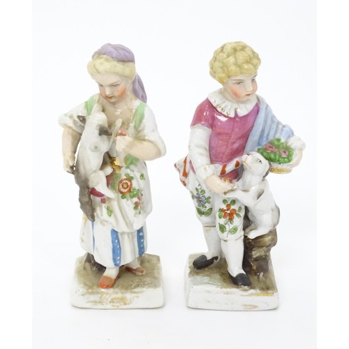 459 - A pair of Continental porcelain figurines, one modelled as a girl with a cat, the other modelled as ... 