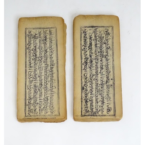 465 - A quantity of parchment leaves of a religious text, having block printed script and some illustratio... 