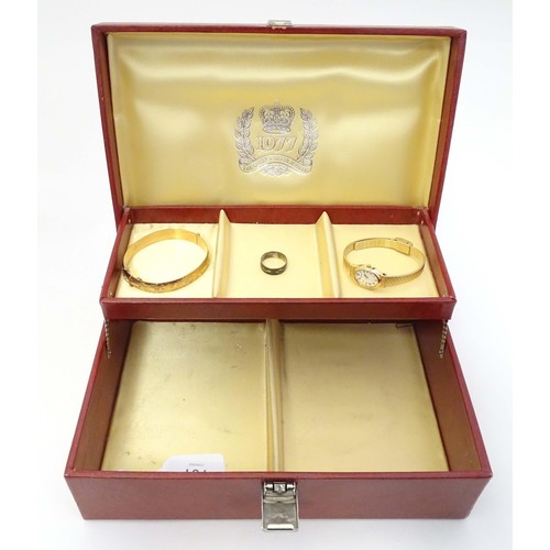 483 - A Queen's silver jubilee 1977 jewellery box containing a rolled gold bangle with engraved decoration... 