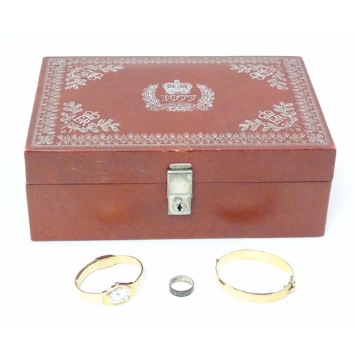 483 - A Queen's silver jubilee 1977 jewellery box containing a rolled gold bangle with engraved decoration... 