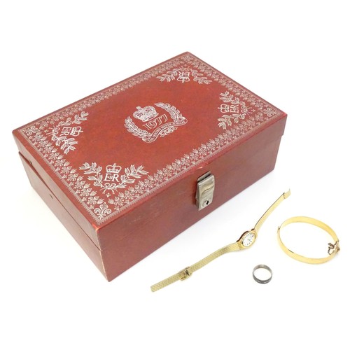 483 - A Queen's silver jubilee 1977 jewellery box containing a rolled gold bangle with engraved decoration... 