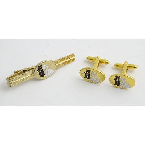 498 - A novelty advertising tie pin and cufflinks for Black & White whisky, with dog detail.