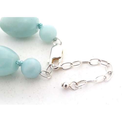 507 - A jade coloured bead necklace together with a matching bracelet. The necklace approx. 18