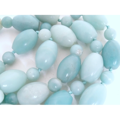 507 - A jade coloured bead necklace together with a matching bracelet. The necklace approx. 18