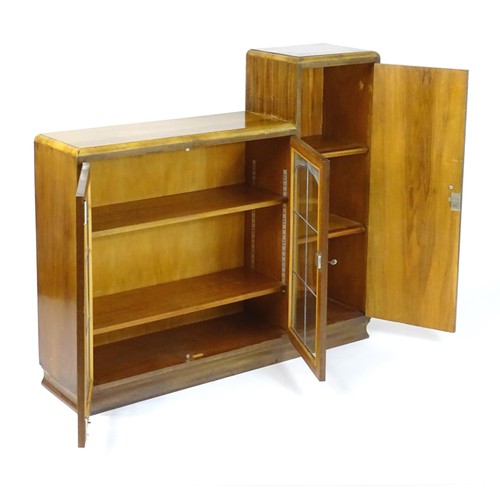 535 - A mid 20thC walnut Art Deco bookcase with two glazed doors and a single walnut door containing shelv... 