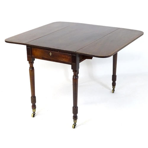 542 - An early / mid 19thC mahogany Pembroke table with a rectangular top flanked by drop flaps with eboni... 