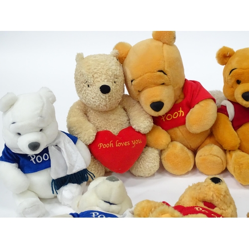 543 - A quantity of assorted Winnie the Pooh soft / cuddly toys to include examples from the Disney Store,... 