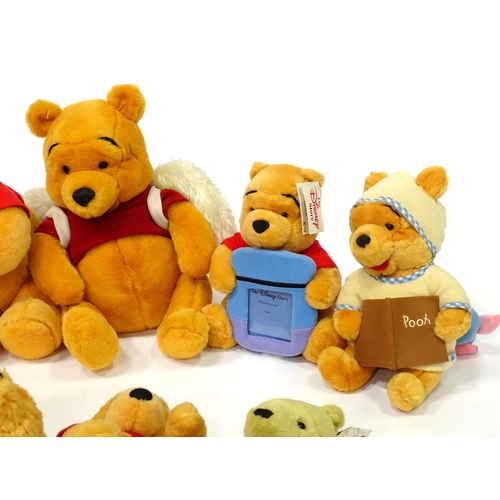 543 - A quantity of assorted Winnie the Pooh soft / cuddly toys to include examples from the Disney Store,... 