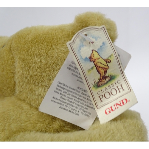 543 - A quantity of assorted Winnie the Pooh soft / cuddly toys to include examples from the Disney Store,... 