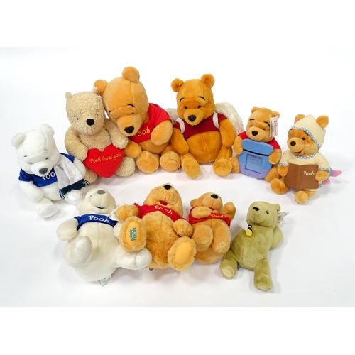 543 - A quantity of assorted Winnie the Pooh soft / cuddly toys to include examples from the Disney Store,... 