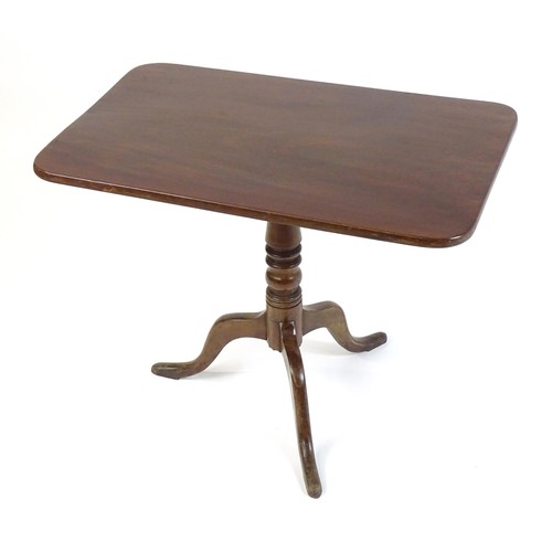 544 - An early 19thC mahogany tripod table with a rectangular top above a turned stem and three cabriole l... 