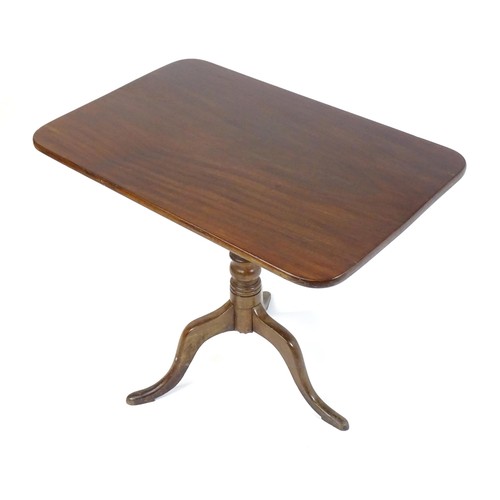 544 - An early 19thC mahogany tripod table with a rectangular top above a turned stem and three cabriole l... 