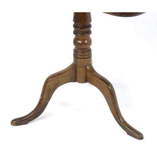 544 - An early 19thC mahogany tripod table with a rectangular top above a turned stem and three cabriole l... 