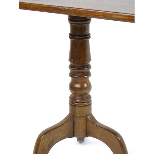 544 - An early 19thC mahogany tripod table with a rectangular top above a turned stem and three cabriole l... 