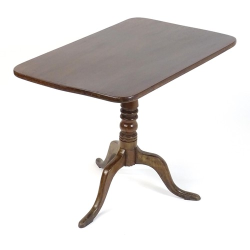 544 - An early 19thC mahogany tripod table with a rectangular top above a turned stem and three cabriole l... 