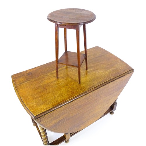 548 - A 20thC oak gateleg table together with a small oval side table raised on tapering legs. The largest... 