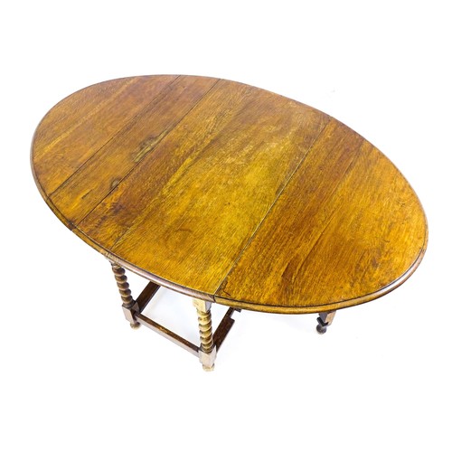 548 - A 20thC oak gateleg table together with a small oval side table raised on tapering legs. The largest... 