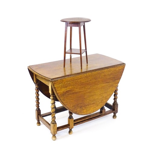 548 - A 20thC oak gateleg table together with a small oval side table raised on tapering legs. The largest... 