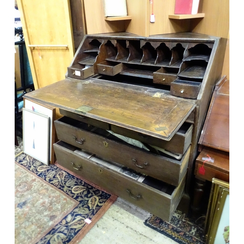 574 - An 18thC oak bureau with fall front over two short over two long drawers with swan neck handles. The... 